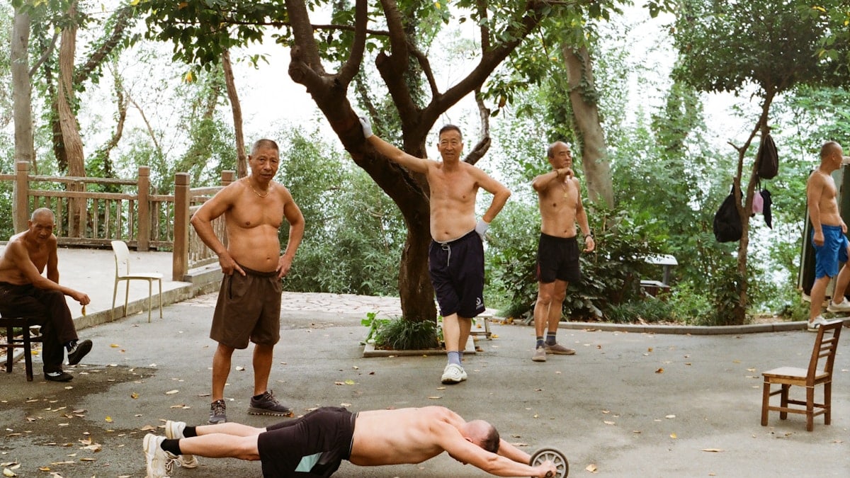 Men exercising outdoors with an ab roller wheel